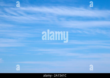 Wispy white clouds against a blue sky Stock Photo