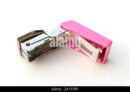 Small pink stapler isolated on white background. Stock Photo