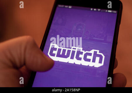 Carrara, Italy - September 24, 2019: Man run Twitch application on a smartphone. Twitch is a live streaming platform owned by Amazon Stock Photo