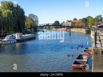 TWICKENHAM, RICHMOND, LONDON, UK - SEPTEMBER 20, 2019: View along the Thames river to the bridge which leads to Eel PIe island on the left. Sunny day. Stock Photo