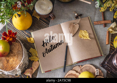 Autumn set of yellow leaves and flowers. Notebook with open pages on the table. Space for text. Top view. Concept Hello autumn Stock Photo