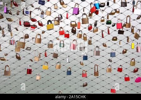 Many colorful locks as the symbol of eternal love on the bridge of Austria Stock Photo