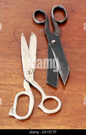 Pair of old rusty vintage scissors on wooden table. Tailor concept Stock Photo
