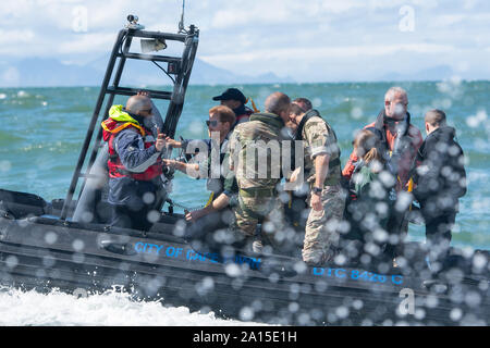 The Duke of Sussex (second left) travels on a South African Maritime Police Unit RIB during a visit to Kalk Bay Harbour, in Cape Town, on day two of the Royal couple's visit to South Africa. Stock Photo