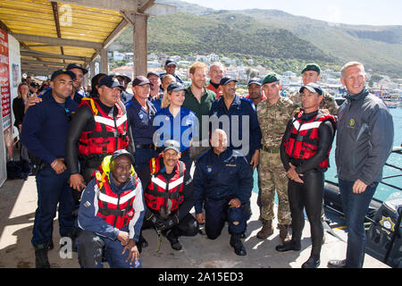 The Duke of Sussex poses for a photo with South African Maritime Police Unit staff at Kalk Bay Harbour, in Cape Town during day two of the Royal couple's visit to South Africa. Stock Photo