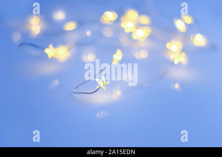 Christmas stars lights on blue background. Christmas festive background Stock Photo