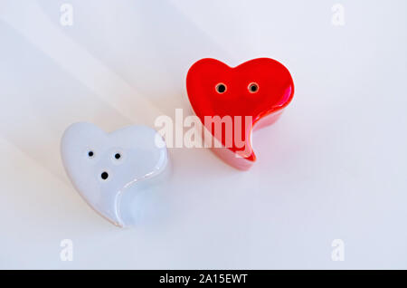 Heart shaped kitchen utensils for salt and pepper. Ceramic salt and pepper shaker. Stock Photo
