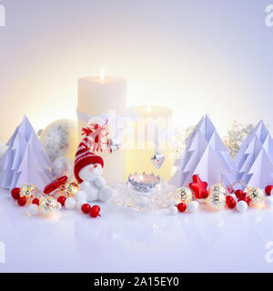 Christmas composition with candles, snowman and paper spruces. Christmas or New Year greeting card. Stock Photo