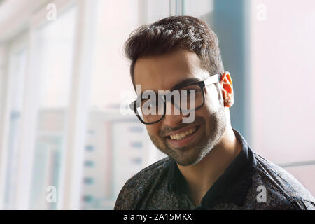 Close up portrait of man smiling, wearing eyeglasses Stock Photo