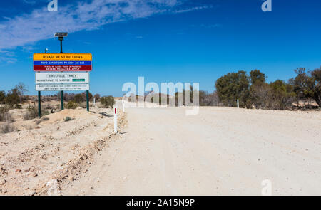 Leaving Mungeranie heading south, this road restrictions sign informs drivers if the remainder of the Birdsville Track is open all the way to Marree Stock Photo