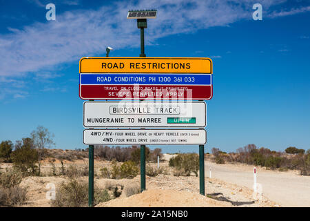 Leaving Mungeranie heading south, this road restrictions sign informs drivers if the remainder of the Birdsville Track is open all the way to Marree Stock Photo