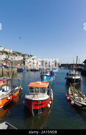 Mevagissey harbour with boats at anchor the village is within the Cornish Area of Outstanding Natural Beauty Stock Photo