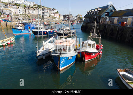 Mevagissey harbour with boats at anchor the village is within the Cornish Area of Outstanding Natural Beauty Stock Photo