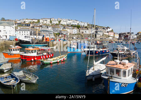 Mevagissey harbour with boats at anchor the village is within the Cornish Area of Outstanding Natural Beauty Stock Photo