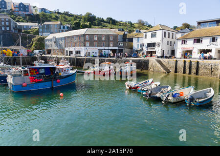 Mevagissey harbour with boats at anchor the village is within the Cornish Area of Outstanding Natural Beauty Stock Photo