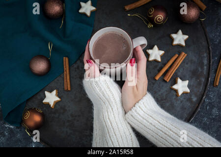 Woman's hands holding cup of Hot Chocolate at Christmas time Stock Photo