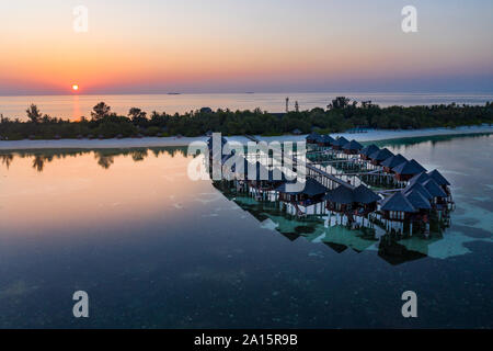Maldives, Olhuveli island, Resort bungalows on South Male Atoll lagoon at sunset Stock Photo