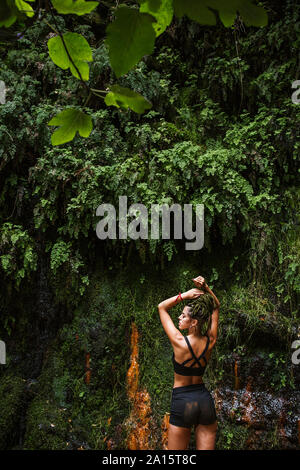 Sportive young woman with braids in forest Stock Photo