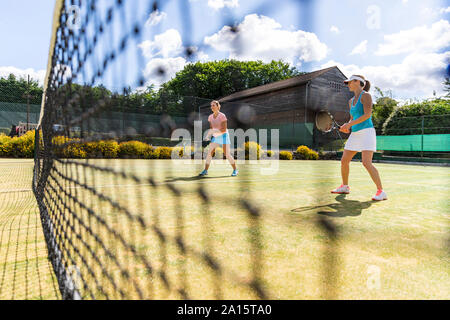 Mature women during a tennis match on grass court Stock Photo
