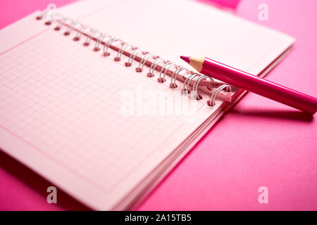 Close up of open notebook and pencil on blurred desk Stock Photo