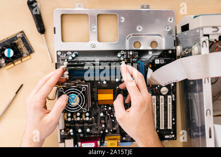 Close-up of technician repairing a desktop computer, changing the computer's RAM Stock Photo