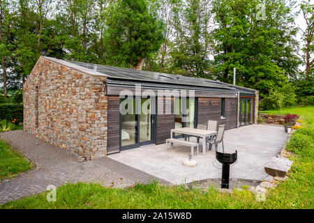 Detached house with solar panels on the roof Stock Photo