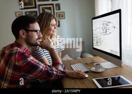 Young attractive designers working together from home Stock Photo