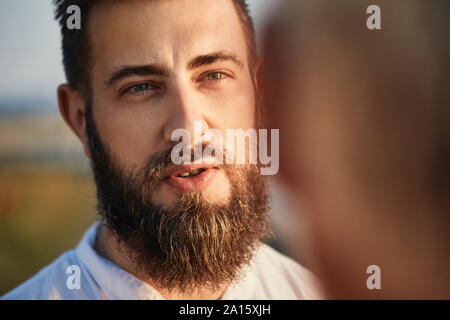 Adult son talking with father outdoors Stock Photo