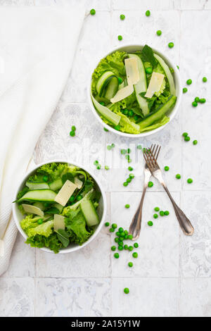 Directly above view of fresh salad in bowls by napkin and forks Stock Photo