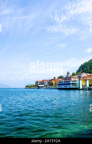 Ferry boat moored in Lake Como against blue sky Stock Photo