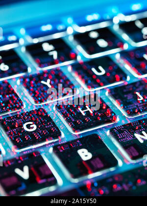 Double exposure of a laptop computer showing electronic components under the keyboard Stock Photo