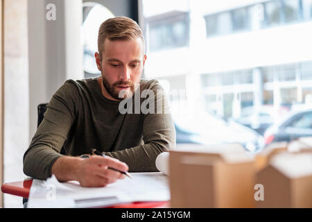 Architect working on plan in office Stock Photo