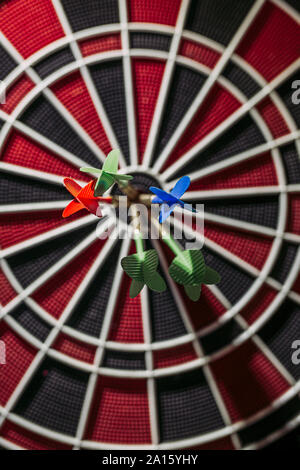 Close-up of darts in bull's eye of electronic dartboard Stock Photo