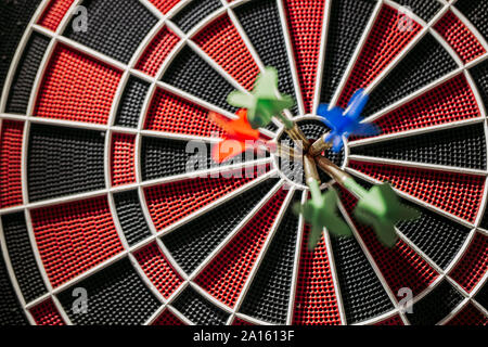 Close-up of darts in bull's eye of electronic dartboard Stock Photo