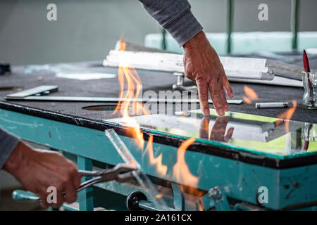Glazing, glazier during work, cutting glass with glass cutter stock photo