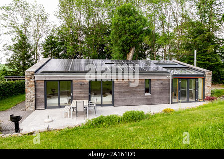 Detached house with solar panels on the roof Stock Photo