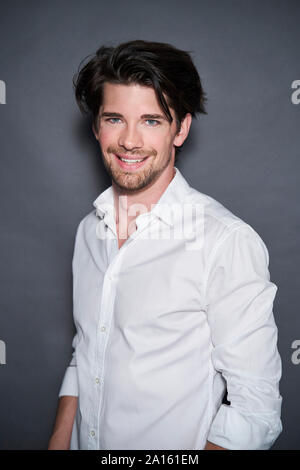 Portrait of smiling handsome man wearing white shirt Stock Photo