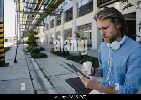 Young man using tablet in the city Stock Photo