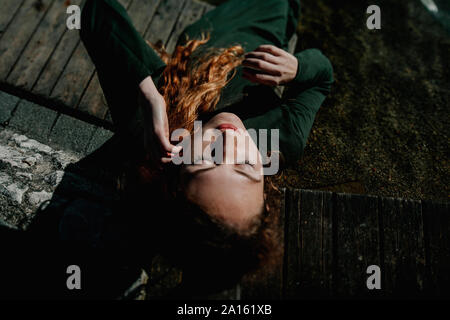 Portrait of redheaded woman lying Stock Photo