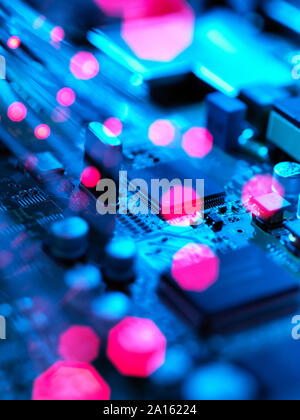 Fibre optics carrying data passing across electronic circuit board Stock Photo