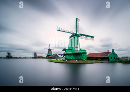 De Gekroonde Poelenburg by Zaan river against sky at Zaanse Schans, Zaandam, Netherlands Stock Photo