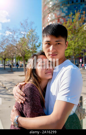 Happy young couple hugging outdoors Stock Photo