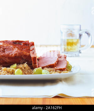 Kasseler with sauerkraut and grapes in table Stock Photo
