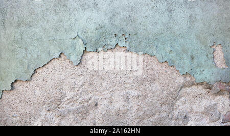 Two fragments of the house vintage wall are covered with green and gray  textured aged broken  plaster Stock Photo
