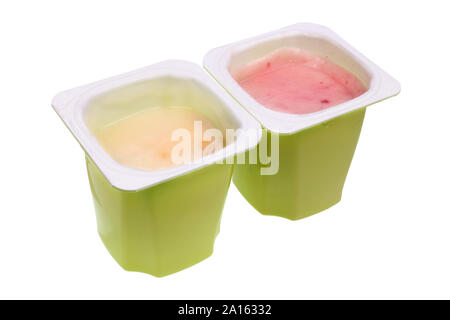 Real nonfat fruits  yogurt in green open plastic cups . Isolated on white studio food  macro Stock Photo