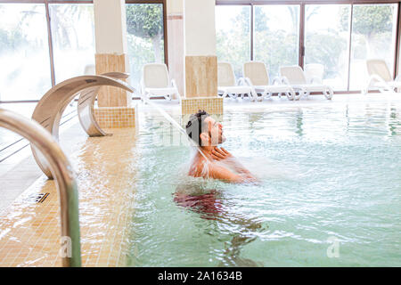 Man relaxing in swimming pool of a spa Stock Photo