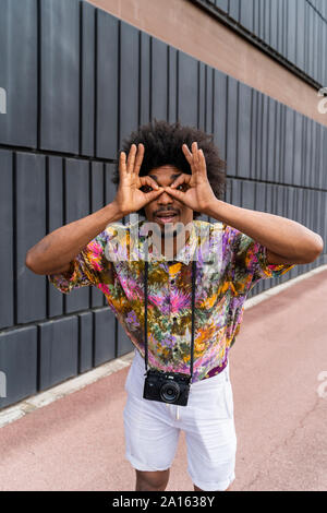 Portrait of man with a camera wearing colorful shirt Stock Photo