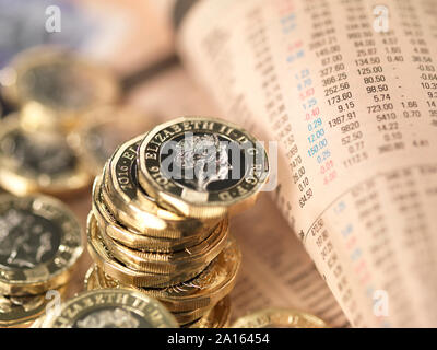 UK Finance and Economy, UK pound coins on a financial newspapers share price page Stock Photo