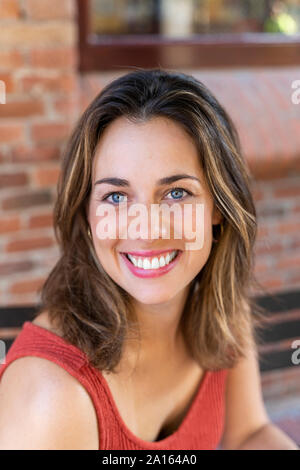 Portrait of happy young woman with blue eyes Stock Photo
