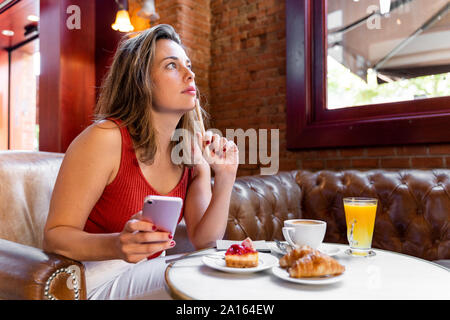 Young blogger working in a cafe Stock Photo